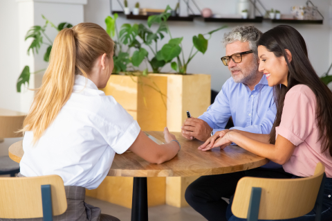 female agent presenting content tablet couple young mature customers